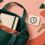 Paper-cut illustration of a bag with a notebook, a clock card and a key beside a path to a doorway.