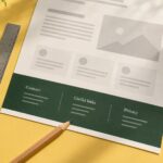 A printed website proof on a yellow desk, with a green footer labelled Contact, Useful links and Privacy.